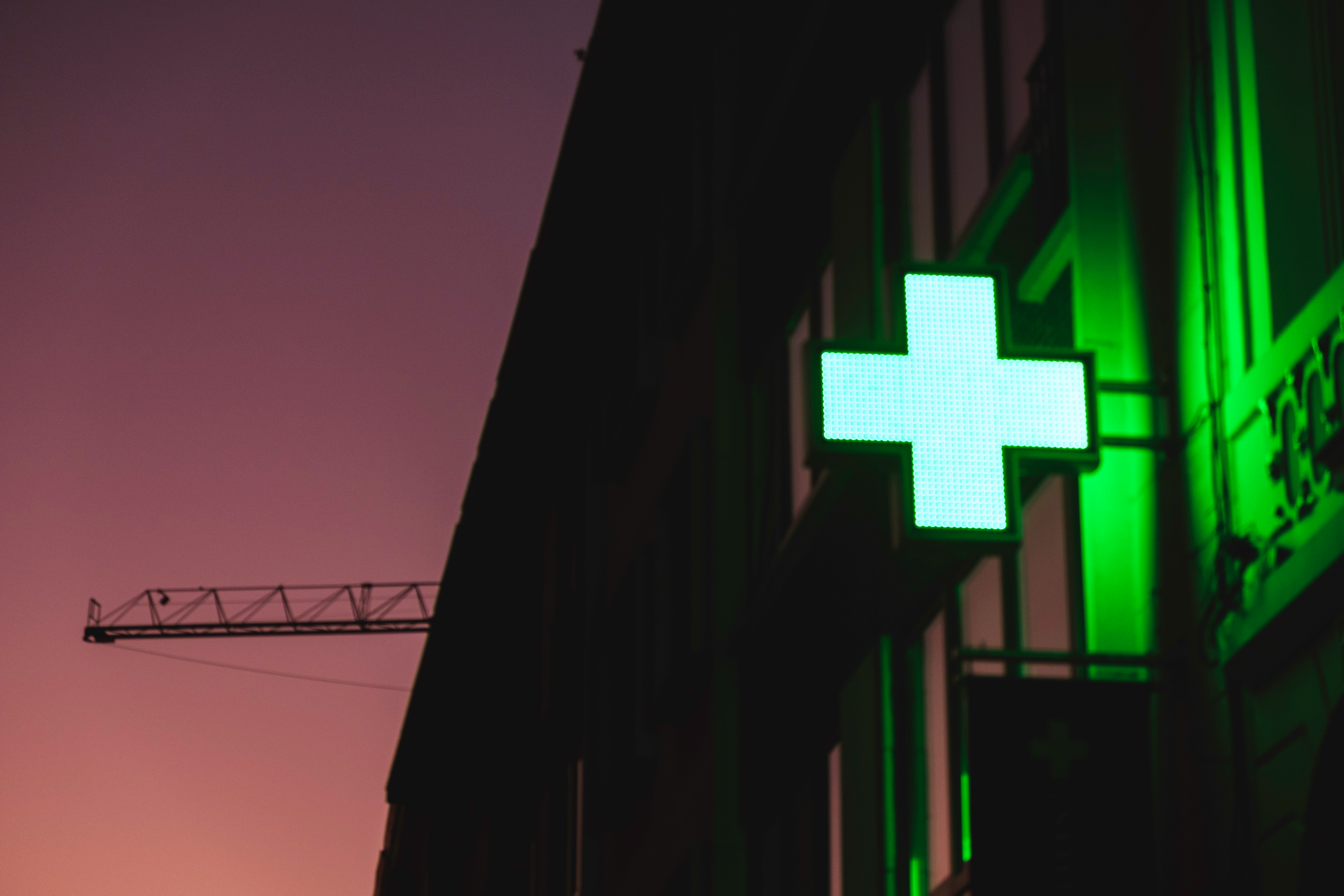 A French pharmacie sign at dusk