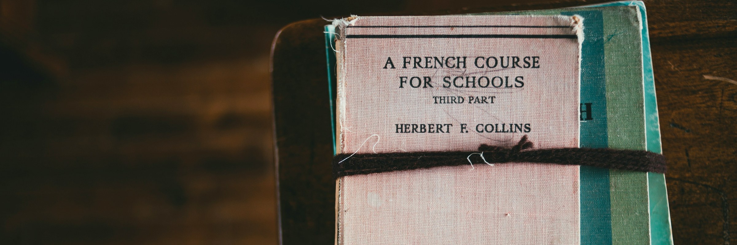 A bundle of vintage French course books tied with string
