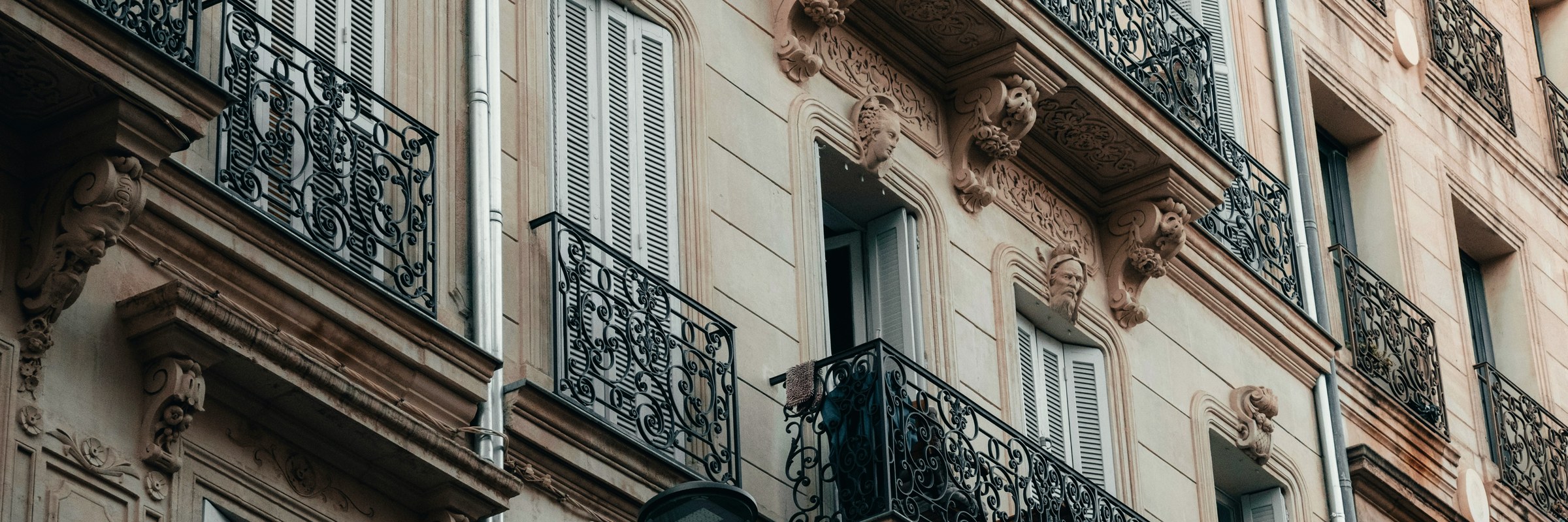 Ornate wrought-iron balconies on a Haussmann apartment building